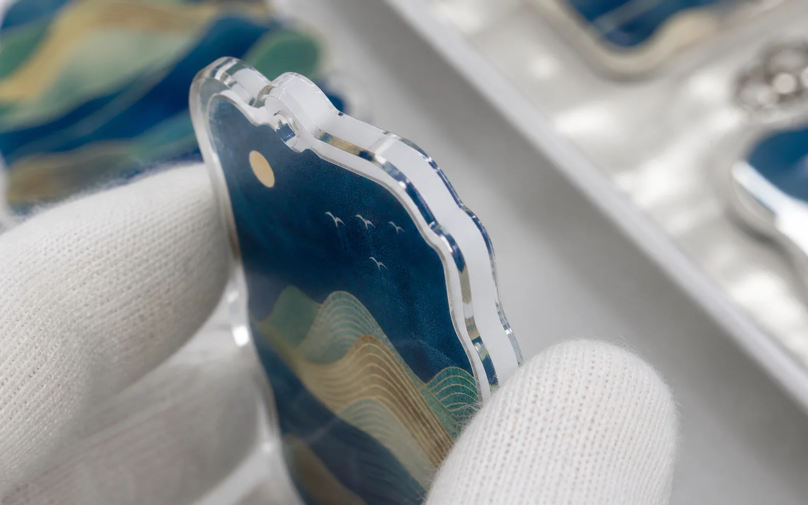 Close-up of a night-sky acrylic tag with a satin surface finish