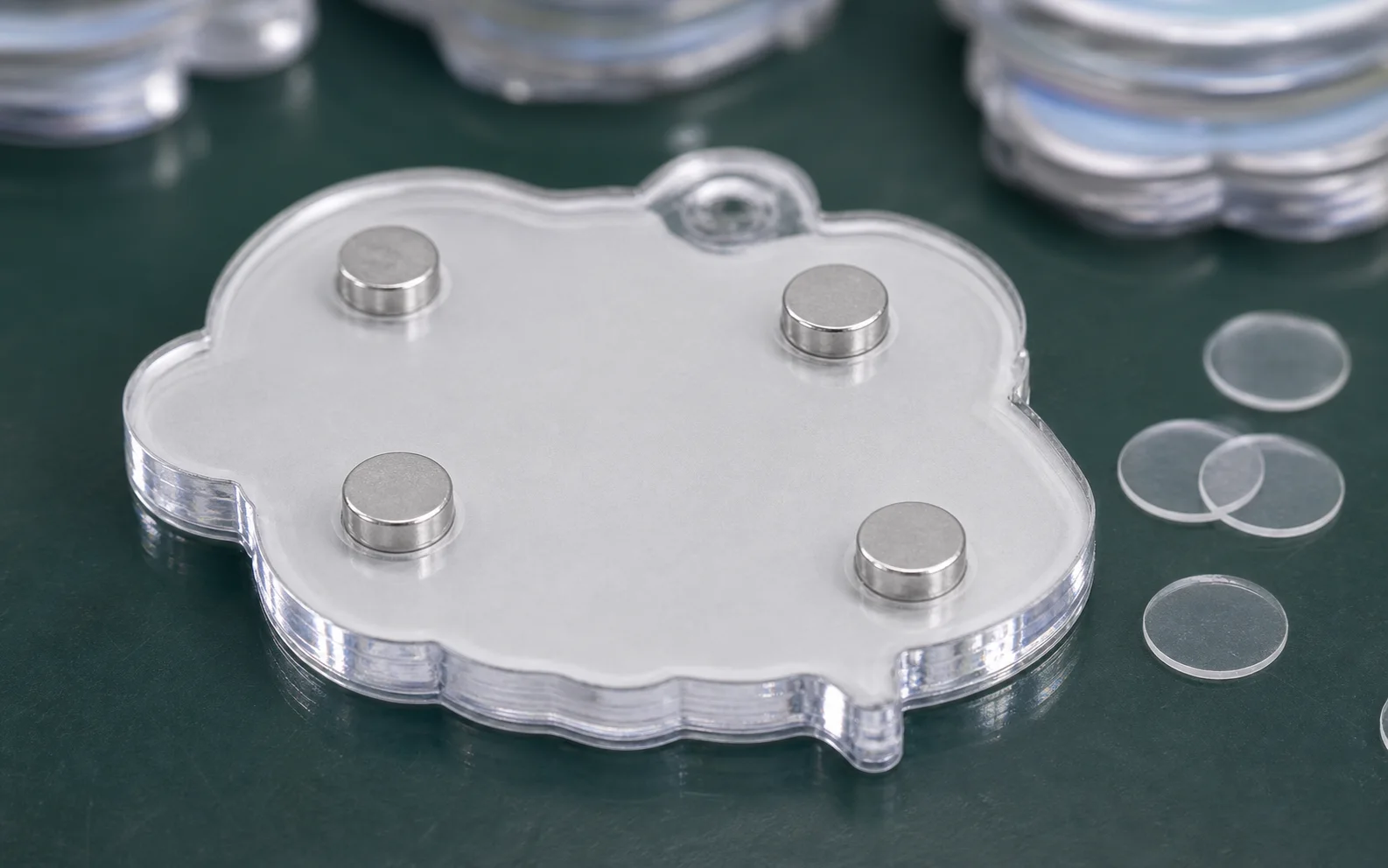 Close-up of magnet discs mounted on the back of a die-cut acrylic piece