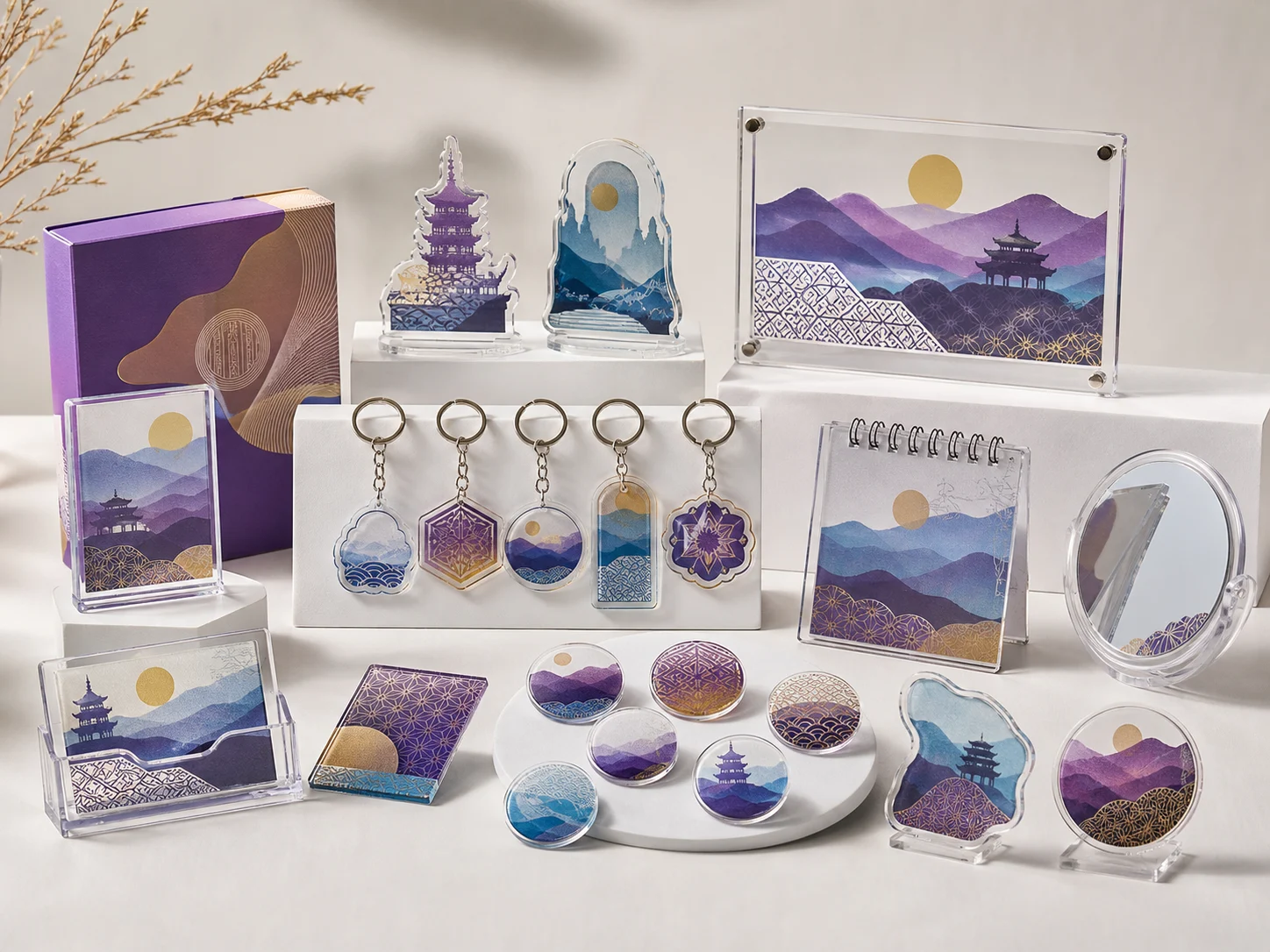 A cultural merch set sharing one pagoda-and-mountain artwork — plaque, keychains, badges, and mirror